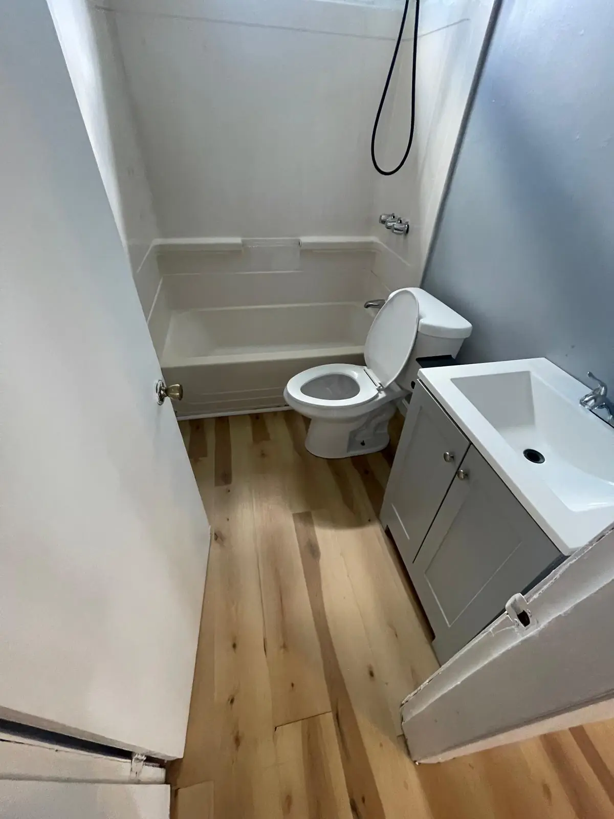Clean bathroom with shower and tub combo after cleaning in Clinton, MA