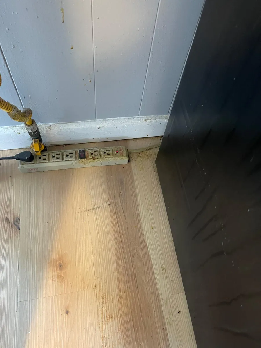 Hardwood floor and baseboard after a post-construction cleaning in Clinton, MA — clean boards and trim