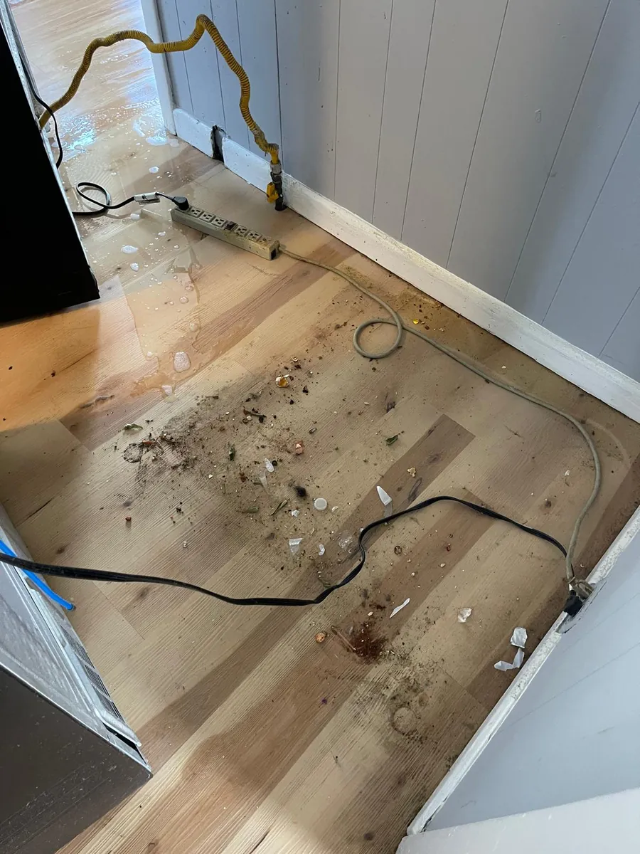 Hardwood floor before post-construction cleaning in Clinton, MA, covered in debris, dust and dried spills