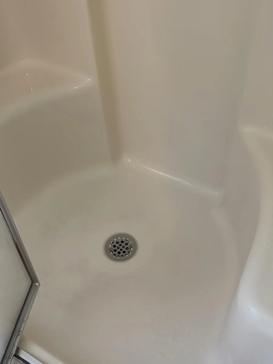 Shower pan and drain after mold removal in Clinton, MA — clean white surface