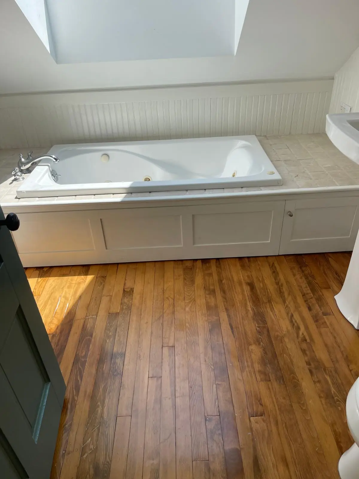 Clean jacuzzi soaking tub under a skylight after cleaning in Clinton, MA